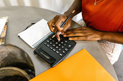 woman uses calculator to work out math problems
